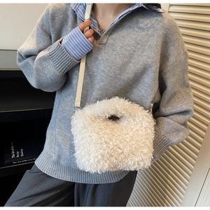 Detail of white faux shearling crossbody bag with premium leather strap and fluffy texture
