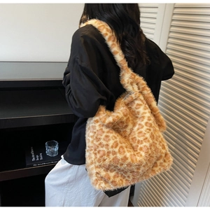 Detailed view of the large plush leopard print tote bag on a model shoulder for autumn winter