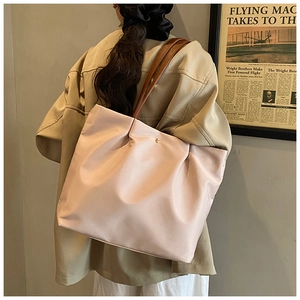 Detail of pink large tote bag with brown leather straps and gold buckle closure