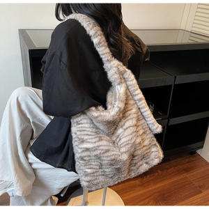 Close-up of fluffy tiger stripe faux fur tote bag showing plush texture and spacious design