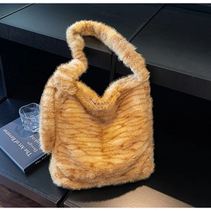 Detail view of large orange tiger stripe plush tote bag with soft faux fur texture