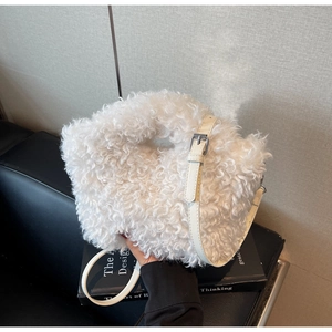 Detail of white faux fur shoulder bag texture with slim leather strap and silver buckle