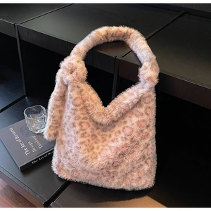 Detail of soft leopard print faux fur tote bag with pink and brown knotted shoulder strap