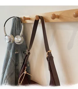 Detail of adjustable metal buckle on brown vintage tote bag strap for shoulder length adjustment