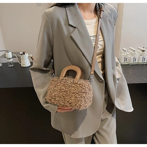 Brown faux shearling mini tote bag with leather handles and detachable crossbody strap