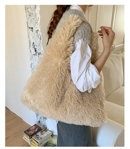 Detail of soft beige faux fur tote bag showing the plush texture in a cozy home setting