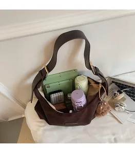 Interior view showing the large capacity of the brown suede tote bag with daily items