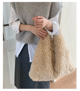 Close-up of beige plush tote bag showing soft fluffy texture and minimalist design