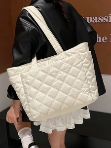 Quilted nylon tote bag in off-white featuring a spacious design and wide shoulder strap