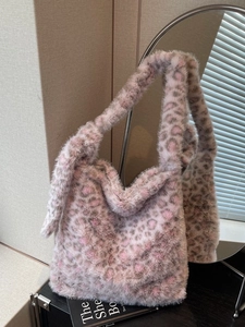 Pink and grey faux fur leopard print hobo shoulder bag for women in a stylish setting
