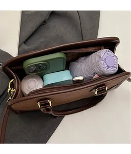 Top view of dark brown Boston bag interior showing spacious capacity for daily essentials