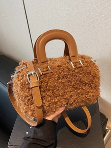 Brown teddy faux fur cylinder handbag with smooth leather handles and silver hardware