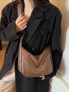 Brown vintage minimalist dumpling shoulder bag in premium faux leather with wide strap