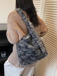 Faux fur tiger stripe tote bag in grey plush material with spacious shoulder strap