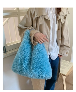 Macro view of plush light blue tote bag showing soft lamb wool texture and fiber details
