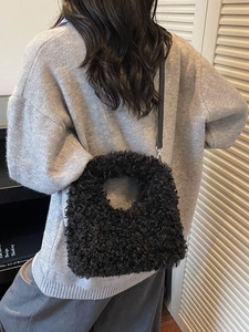 Chic black fuzzy faux fur handbag for women with adjustable leather shoulder strap