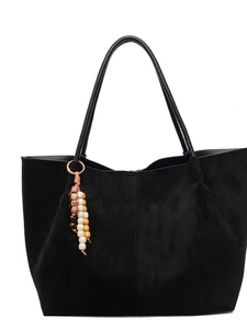 Large black faux suede tote bag with decorative beaded tassel and minimalist design