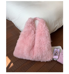 Detail view of pink plush tote bag with soft faux fur texture and leather handle