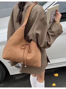 Brown faux suede large tote bag with drawstring detail shown on street model