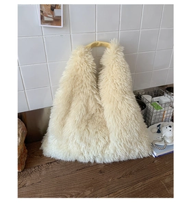 Close-up of fluffy faux fur tote bag showing plush texture and smooth faux leather handles