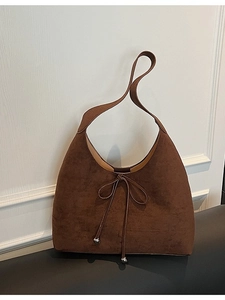 Dark brown suede hobo shoulder bag with bow detail and silver metal charms