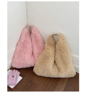 Detail view of pink and beige plush tote bags featuring soft faux fur and fluffy top handles