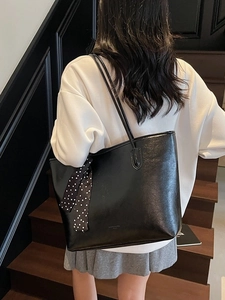 Classic black leather tote bag with polka dot scarf and long shoulder straps for women