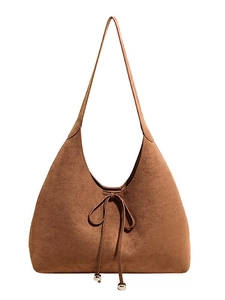 Vintage brown suede hobo bag with drawstring bow and metallic details on white background