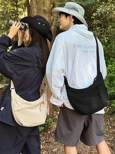 Minimalist nylon crescent crossbody bags in black and white for outdoor leisure activities