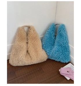 Detailed view of beige and blue plush tote bags with soft faux fur texture for autumn