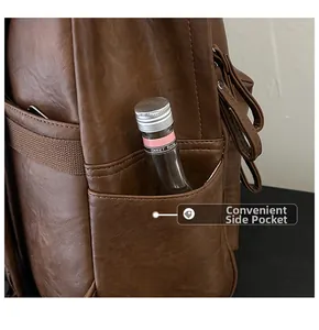 Detail view of the side pocket on a vintage brown leather backpack with neat stitching