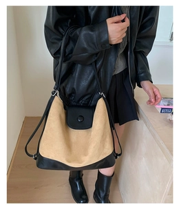 Crossbody view of large khaki and black patchwork tote bag with suede texture detail