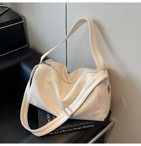 Close-up of cream white tote bag with vintage wrinkled texture and silver buckle