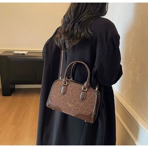 Detail of vintage brown leopard print crossbody bag with fashion leather embossing