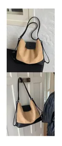 Detail of a khaki canvas and black leather tote bag showing crossbody strap and texture