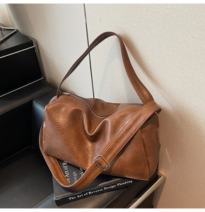 Macro shot of brown PU leather texture and adjustable strap on a vintage tote bag
