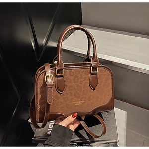 Detail of Boston bag with brown leather and leopard print suede stitching