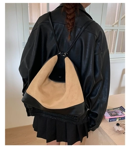 Detail of vintage matte large backpack on model showing brown and black leather mix