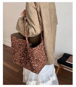 Detailed shoulder view of a large leopard print tote bag with premium canvas texture