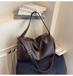 Detail view of the soft vintage dark brown faux leather tote with a smooth metal zipper