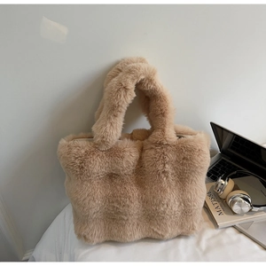 Détail d'un sac cabas en fausse fourrure douce avec ordinateur et casque sur le côté