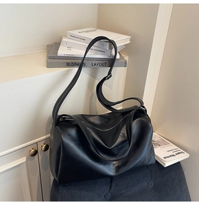 Detailed close-up of high-quality black PU leather texture on a spacious tote bag