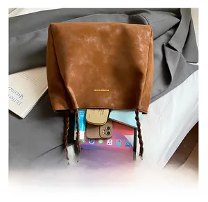 Macro shot of large capacity brown suede tote bag showing internal storage space and texture
