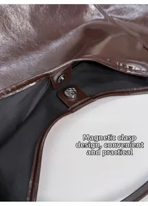 Macro view of magnetic closure and dark brown leather texture on a bucket bag