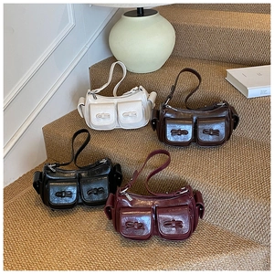 Four vintage shoulder bags in beige, brown, black and red on steps with soft lighting