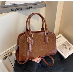 Detail of leopard print suede and brown leather texture on a vintage square handbag