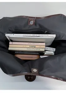 Top view of large brown tote bag interior with magnetic closure and inner zipper pocket