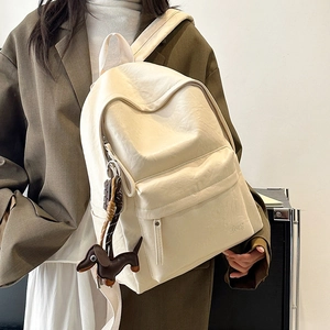Detail of off-white backpack texture with Keep embossed logo and dog charm detail