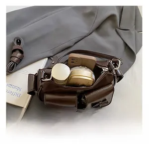 Detail view of the spacious inner compartment and ribbon pockets on this dark brown bag