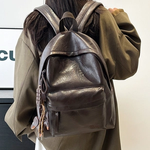 Detailed back view of a dark brown vintage PU leather backpack with side zip pockets